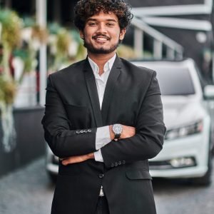 Indian businessman in the background of his white car DUBAI TOUR PACKAGE